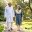 Senior couple enjoying a healthy morning walk in a park representing active lifestyle and Ayurvedic wellness for joint health.
